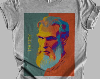 May include: A gray t-shirt featuring a colorful pop art portrait of Leo Tolstoy. The portrait is set against a teal and orange background, with the name "TOLSTOY" printed vertically in gold.