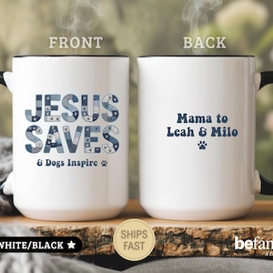May include: A white ceramic mug with a black handle and rim. The front features the blue text JESUS SAVES & Dogs Inspire with a paw print. The back displays the blue text Mama to Leah & Milo with a paw print. The mug is labeled as 15oz.