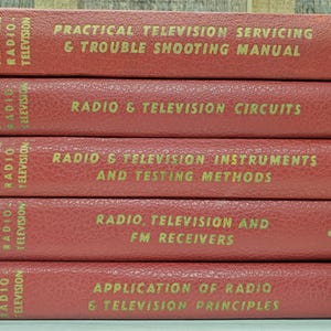 May include: A stack of five red books with gold lettering. Titles include "Practical Television Servicing," "Radio & Television Circuits," and "Application of Radio & Television Principles."