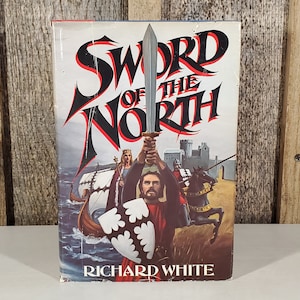 May include: A paperback book cover with a red and black illustration of a sword and the text "Sword of the North" with the author's name "Richard White" at the bottom.