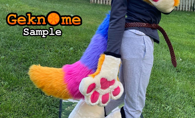 May include: A colorful furry tail and paw costume with orange, pink, purple, and blue sections. The paw has pink pads and is cream-colored. The image includes the text "Geknome Sample" in an orange and black font.