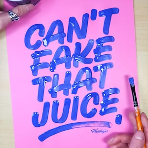 May include: A pink background with the phrase "Can't Fake That Juice." written in blue paint. The phrase is written in a bold, stylized font. A paintbrush is visible in the bottom right corner of the image.