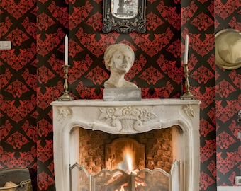 May include: A white marble fireplace mantel with a decorative carved design. The fireplace has a fire burning inside with a metal grate. The mantel is decorated with a bust of a woman and two candlesticks.