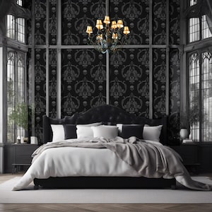 May include: A black bed with a black headboard and a white duvet cover. The bed is in a room with black walls and a chandelier with gold accents. The walls are covered in a black and white skull wallpaper.