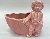 1950s small boy and an upside down shell planter pale pink. 7 inches in length and 5 1 2 inches in height. Totally cool.