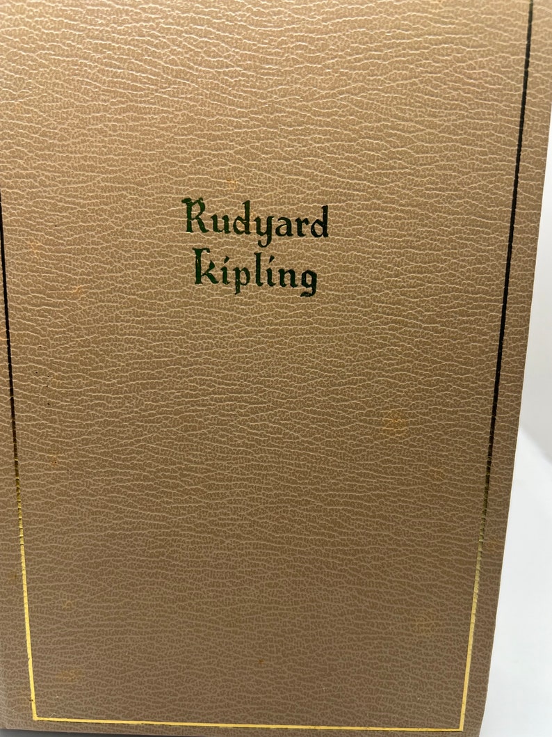 May include: A brown leather-bound book with gold edging. The title "Rudyard Kipling" is embossed in green on the front cover.