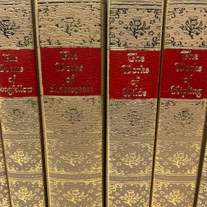 May include: A set of five brown hardcover books with gold accents and red spines. The titles on the spines are "The Poems of Longfellow", "The Works of Shakespeare", "The Works of Wilde", "The Works of Kipling", and "The Works of Poe".