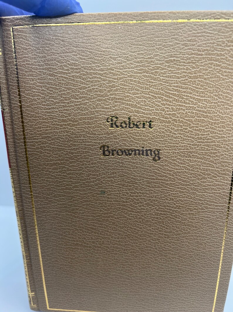 May include: A brown leather-bound book with gold accents and the text "Robert Browning" embossed on the front cover.