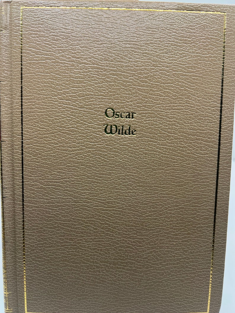 May include: A brown leather-bound book with gold lettering on the front cover that reads "Oscar Wilde".