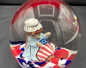 Vintage Joe Rice sulphide glass paperweight depicting Betsy Ross sewing the American Flag. 2003. 3 inches tall and 2 inches wide. Perfect