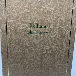 May include: A brown leather-bound book with a gold border and the text "William Shakespeare" embossed in green on the front cover.
