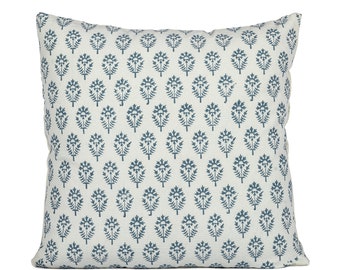 May include: A white throw pillow with a blue floral pattern. The pillow is square and has a white border.