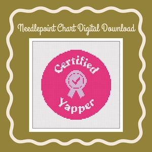 May include: A pink needlepoint chart with a white circle containing the text "Certified Yapper" and a white checkmark inside a ribbon.