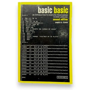 May include: A yellow and black book titled "basic basic" with the subtitle "An introduction to computer programming in BASIC language, second edition" by James S. Coan. The book cover features a code snippet and the results of a program that simulates coin flips.