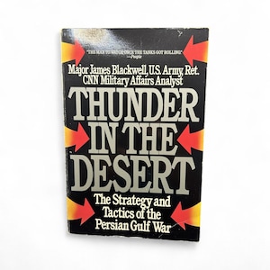 May include: A hardcover book titled "Thunder in the Desert" with a black cover and bold white lettering. The book's title is surrounded by red and yellow arrows. The author is Major James Blackwell, U.S. Army, Ret.