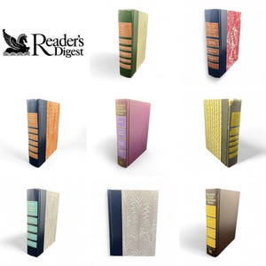 May include: A collection of Reader's Digest Condensed Books in various colors and designs. The books have different colored spines and decorative covers, with the Reader's Digest logo visible in the upper left corner.