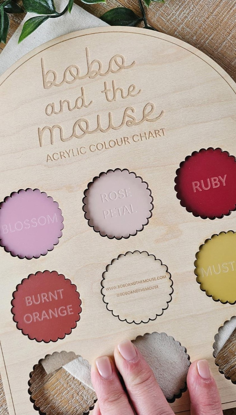 May include: Wooden acrylic color chart with the text "bobo and the mouse". The chart features various color samples, including Blossom, Rose Petal, Ruby, Burnt Orange, and Mustard. The website address is also visible.