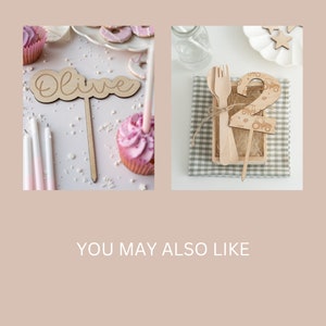 May include: Two wooden cake toppers, one with the name "Olive" and the other with the number "2" decorated with a tractor pattern. Both toppers are on wooden sticks.