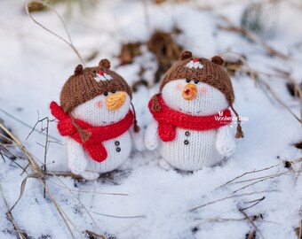 Cute snowman in Teddy bear hat. Interior knitted snowman toy, Christmas tree toy. Knitted New Year's decoration as a gift for Christmas.