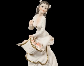A. Belcari Capodimonte figurine of a young woman holding a flower basket