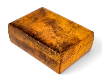 May include: A rectangular wooden box with a rich brown and orange wood grain pattern. The box has a hinged lid and a smooth, polished finish.