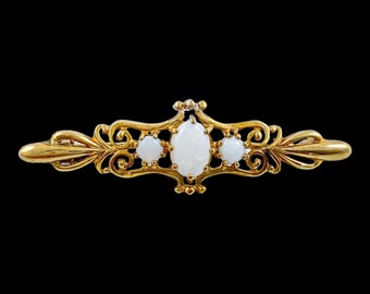 Art Nouveau style 9 kt yellow gold brooch set cabochon opals, scrolling design