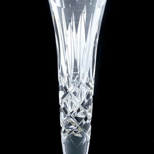 Tall crystal trumpet vase resting on a sterling silver stepped round foot