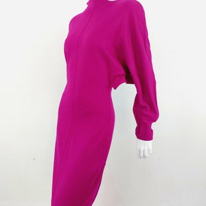 May include: A magenta long-sleeved dress with a high neckline and a fitted silhouette.