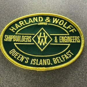 May include: A green and yellow embroidered patch with the text "Harland & Wolff Limited Shipbuilders & Engineers Queen's Island, Belfast" and a diamond-shaped logo with the letters "HW" inside.