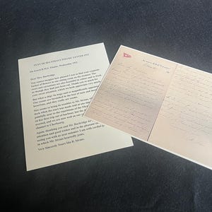 May include: Two vintage letters on a dark surface. One letter is a typed document with the title "TEXT OF IDA STRAUS TITANIC LETTER (1912)". The other letter is handwritten with a small ship emblem at the top.