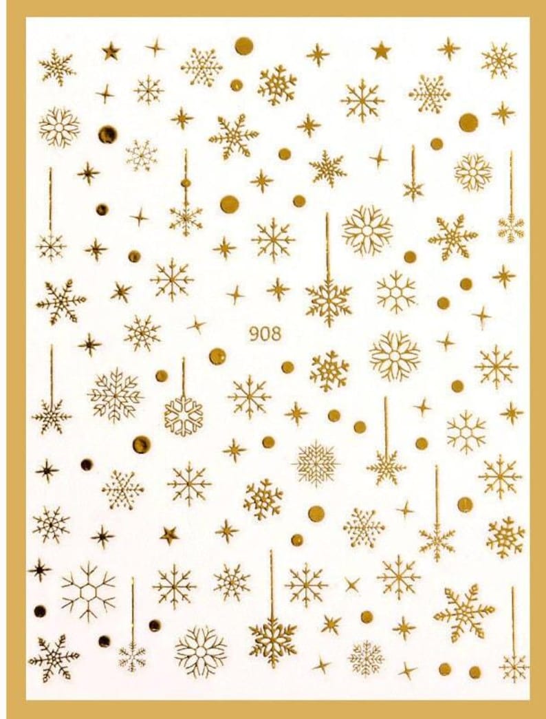 May include: Gold snowflake and star nail stickers. The sheet features a variety of snowflake and star designs in gold foil.