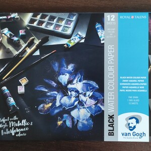 May include: A package of Royal Talens black watercolor paper. The package features a dark background with a blue floral painting and art supplies. The text on the package reads "Black Water Colour Paper" and "Perfect with Van Gogh Metallic & Interference colours."