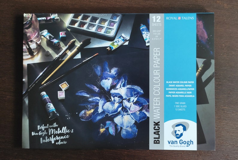 May include: A package of Royal Talens black watercolor paper. The package features a dark background with a blue floral painting and art supplies. The text on the package reads "Black Water Colour Paper" and "Perfect with Van Gogh Metallic & Interference colours."