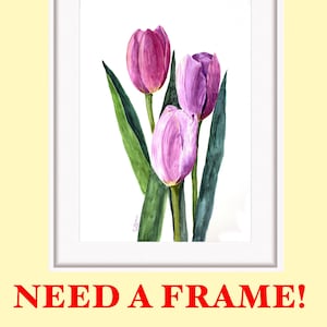 May include: Watercolor painting of three tulips in shades of purple and pink, with green leaves, set against a white background. The artwork is framed in a white rectangular frame. The text "NEED A FRAME!" is below the frame.