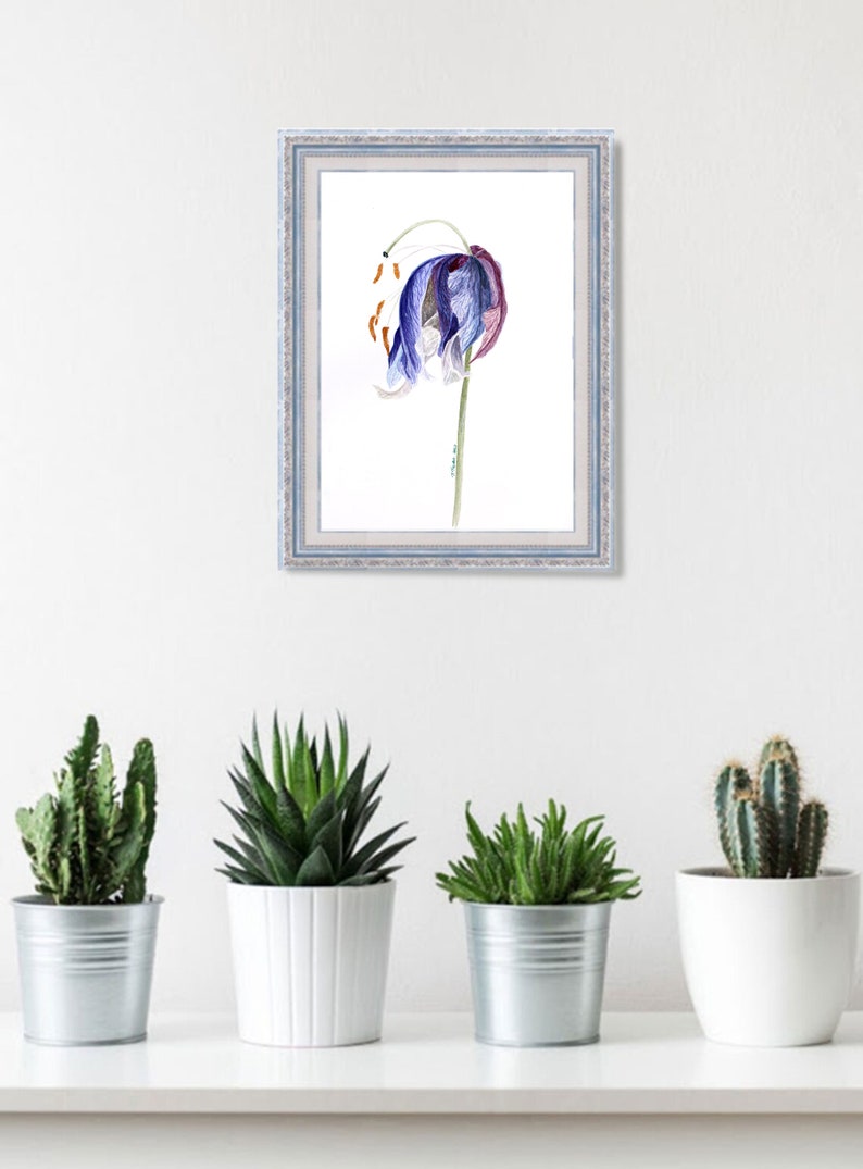 May include: A framed watercolor print of a blue and purple flower with orange accents. The artwork is in a light blue frame and hangs on a white wall above four potted plants: a cactus, a succulent, and two other green plants.