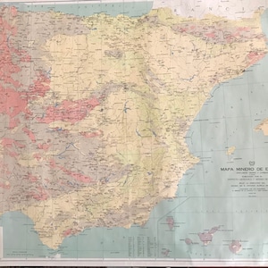 May include: A vintage map of Spain, depicting the country's mineral resources. The map is printed on a pale blue background with a grid pattern. The map is titled "Mapa Minero de Espana" and includes a key with symbols representing different types of minerals.