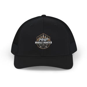 May include: A black trucker cap featuring a mesh back and a front panel embroidered with a hexagonal logo. The logo displays a forest silhouette, the text MHP MOBILE HUNTER PRINTS LLC, two crossed arrows, and the text EST. 2020 in white and tan.