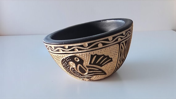 Hand-carved in Ghana with Adinkra symbolism baked in — this is actual cultural craft with a story, not a generic turned bowl.
