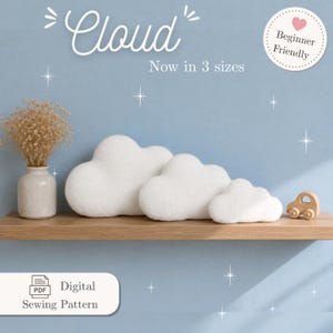 May include: Three white cloud-shaped pillows of varying sizes are displayed on a wooden shelf. The word "Cloud" is written above the pillows. A small wooden car and a vase with dried flowers are also on the shelf. The text "Beginner Friendly" is in a circle.