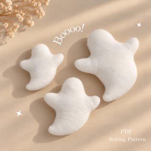 May include: Three white plush ghost-shaped ornaments with soft textures. The text "Boooo!" is printed in white above the ghosts, and the text "PDF Sewing Pattern" is printed in white in the bottom right corner of the image.
