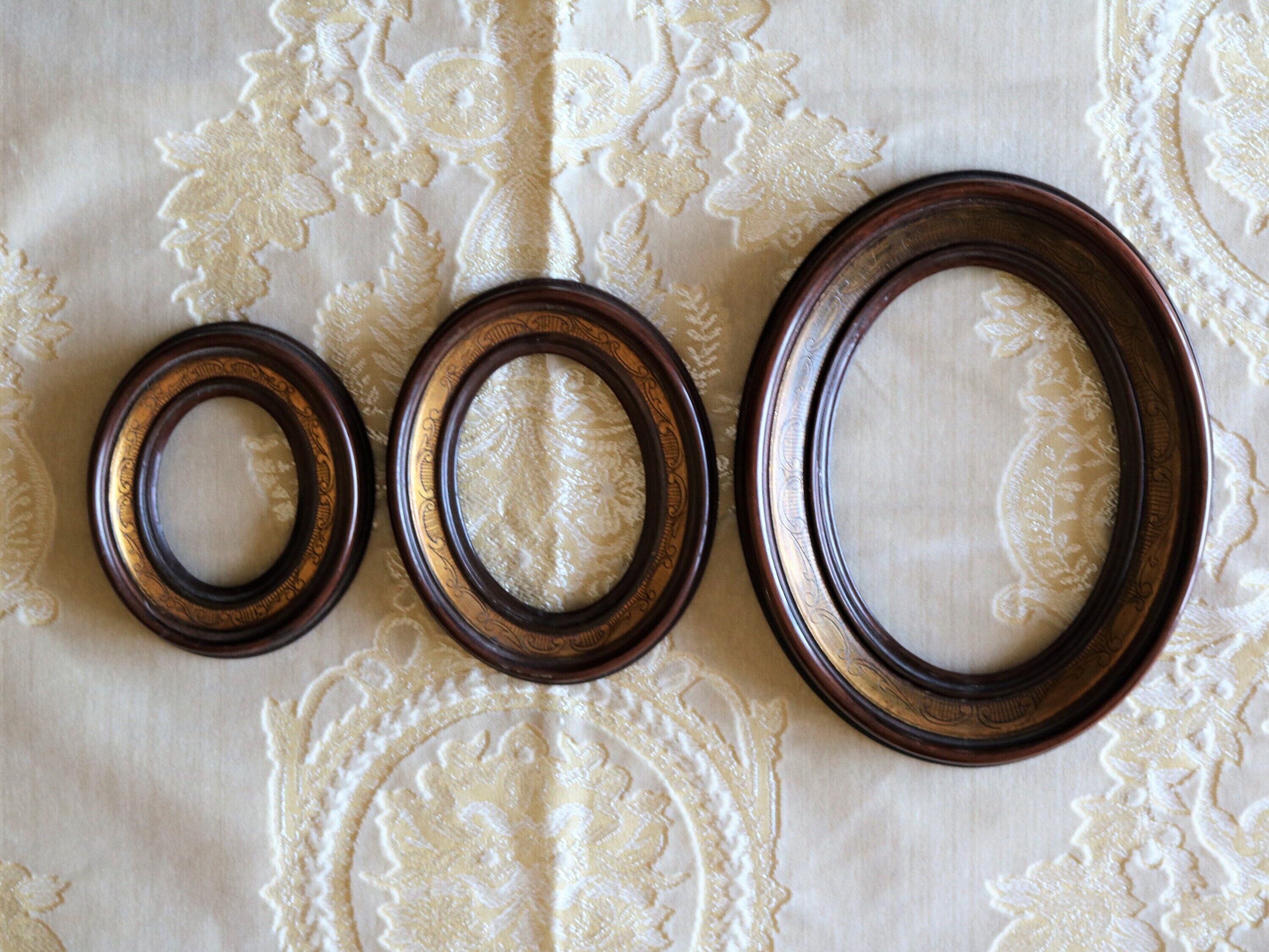 Oval walnut colored frames, historic brand "Cavalli e Poli" from Cremona, set of 3