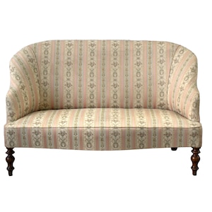 May include: A vintage two-seater sofa with a curved back and armrests. The fabric has a striped pattern in cream, pink, and grey. The wooden legs are dark brown. The style is classic and elegant.
