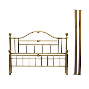 May include: A gold-colored metal bed frame with a curved headboard and footboard. The frame has a classic design with vertical and horizontal bars, and decorative ball finials. Two matching posts stand to the right of the frame.