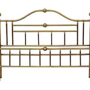 May include: A gold-colored metal bed frame with a headboard. The headboard has a curved top with decorative ball finials and horizontal bars. The frame has vertical supports and additional decorative elements.