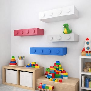 May include: A child's room with colorful decor. Four wall-mounted shelves shaped like large toy bricks in white, pink, gray, and blue. A green dinosaur toy sits on one shelf. Additional toys include building blocks, a rocket, and a wooden train.