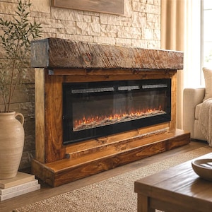 May include: A rectangular electric fireplace featuring a dark, weathered wood mantel and a matching wooden base. The unit has a wide, black glass front panel displaying a glowing orange flame effect with artificial logs visible inside the firebox.