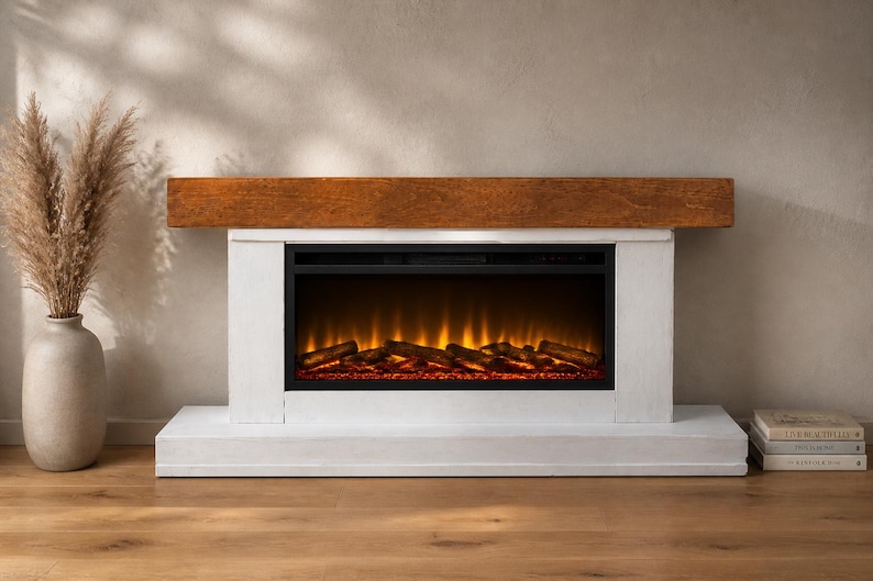 May include: An electric fireplace featuring a white rectangular base and surround with a thick, dark brown wooden mantelpiece. The fireplace insert displays a glowing orange flame effect with dark logs, providing a warm visual light source.