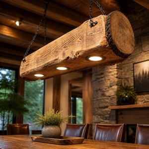 May include: A rustic, wooden beam light fixture with three recessed lights. The fixture is suspended from the ceiling by black chains. The wood has a natural, textured finish, and the end of the beam shows the tree rings. The fixture is in a dining room.