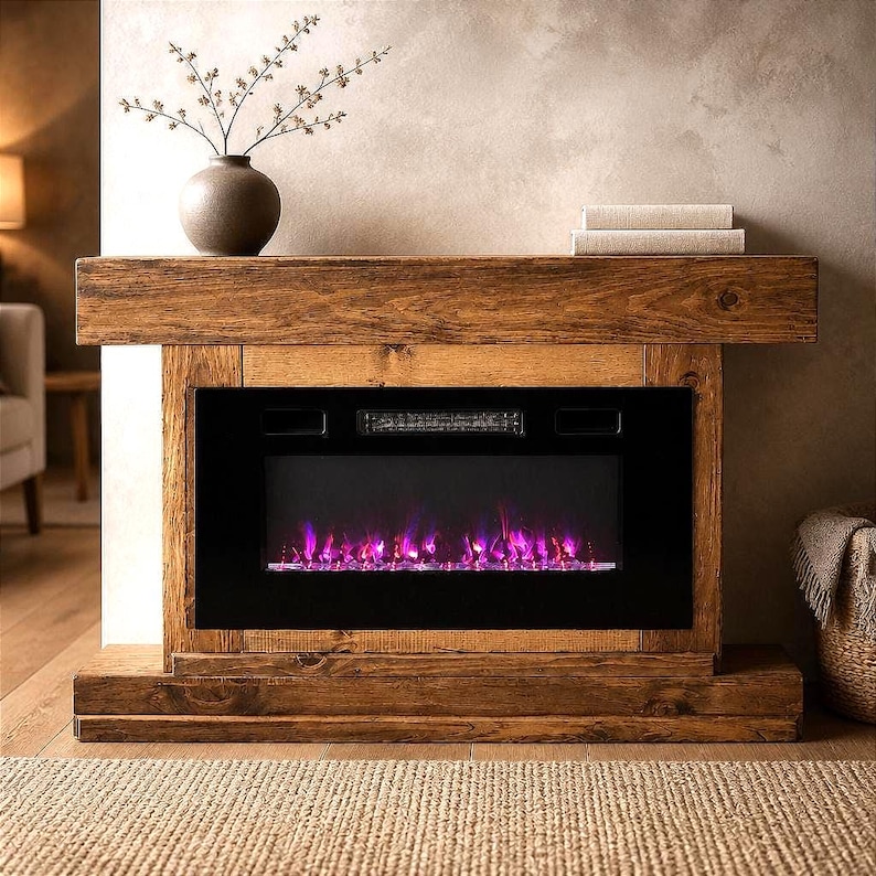 May include: A rustic wooden fireplace mantel featuring a rectangular frame with a dark brown finish and visible wood grain. The center contains a black electric fireplace insert displaying vibrant purple and blue flames behind a glass panel.