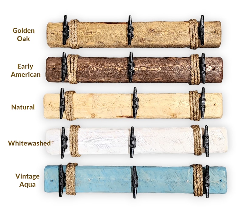 Solid wood nautical theme style look wall mounted coat or towel rack for the bathroom or entryway. This coastal themed towel hooh has rust proof black cast iron boat dock cleats or deck hooks. the wood is distressed and aged with the look of driftwood or reclaimed wood.